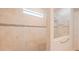 Walk-in shower with beige tile and glass enclosure at 13164 Rinella St, Venice, FL 34293