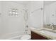 Clean bathroom with white tile, granite vanity, and shower/tub combo at 13421 Gershwin Ln, Port Charlotte, FL 33981