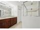 Bathroom boasts double vanity with granite countertop and a large shower at 13421 Gershwin Ln, Port Charlotte, FL 33981