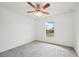 Bedroom with window, ceiling fan, and grey carpet at 13421 Gershwin Ln, Port Charlotte, FL 33981