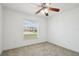 Spacious bedroom with neutral carpet and large window at 13421 Gershwin Ln, Port Charlotte, FL 33981