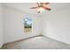 Bedroom with window, ceiling fan and carpet at 13421 Gershwin Ln, Port Charlotte, FL 33981