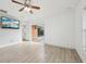 Bright bedroom with wood-look floors, sliding glass door to patio, and ceiling fan at 13421 Gershwin Ln, Port Charlotte, FL 33981