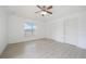 Bedroom with wood-look floors, ceiling fan and window at 13421 Gershwin Ln, Port Charlotte, FL 33981