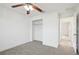 Bright bedroom with ceiling fan, carpet, and ample closet space at 13421 Gershwin Ln, Port Charlotte, FL 33981