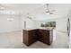 Large kitchen island with granite countertops and dark wood cabinets at 13421 Gershwin Ln, Port Charlotte, FL 33981