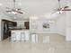 Open floor plan showing kitchen, dining, and living areas with tile floors at 13421 Gershwin Ln, Port Charlotte, FL 33981