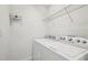 Laundry room with Whirlpool washer and dryer and overhead shelving at 13421 Gershwin Ln, Port Charlotte, FL 33981
