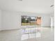 Spacious living area with glass doors and tile floor at 13421 Gershwin Ln, Port Charlotte, FL 33981