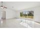 Living room with tile floors and sliding glass doors at 13421 Gershwin Ln, Port Charlotte, FL 33981