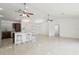 Spacious living area and kitchen with tile floors and ceiling fans at 13421 Gershwin Ln, Port Charlotte, FL 33981