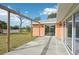 Concrete patio area with pergola and access to backyard at 13421 Gershwin Ln, Port Charlotte, FL 33981