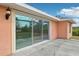 Back patio with sliding glass doors and pergola at 13421 Gershwin Ln, Port Charlotte, FL 33981