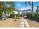 Landscaped backyard with stone pathway at 1348 Reserve Dr, Venice, FL 34285