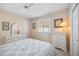 Bedroom with a double bed, dresser, and window with plantation shutters at 1348 Reserve Dr, Venice, FL 34285