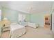 Two twin beds, white dresser, and window with plantation shutters at 1348 Reserve Dr, Venice, FL 34285