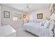 Bedroom with a double bed, dresser, and window with plantation shutters at 1348 Reserve Dr, Venice, FL 34285