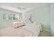Two twin beds, white dresser, and window with plantation shutters at 1348 Reserve Dr, Venice, FL 34285