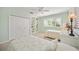 Two twin beds, built-in shelving, and window with plantation shutters at 1348 Reserve Dr, Venice, FL 34285