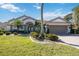 Beautiful one-story home with a tile roof, landscaping, and a two-car garage at 1348 Reserve Dr, Venice, FL 34285