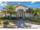 Inviting front entrance with double doors and lush landscaping at 1348 Reserve Dr, Venice, FL 34285