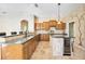 Spacious kitchen with island, granite countertops, and wood cabinets at 1348 Reserve Dr, Venice, FL 34285