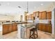Gourmet kitchen with wood cabinets, granite countertops, and an island at 1348 Reserve Dr, Venice, FL 34285
