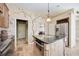Kitchen island with built-in wine cooler and stainless steel appliances at 1348 Reserve Dr, Venice, FL 34285