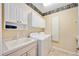 Laundry room with washer, dryer, sink, and upper cabinets at 1348 Reserve Dr, Venice, FL 34285