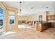 Living room with fireplace and view into kitchen and dining area at 1348 Reserve Dr, Venice, FL 34285