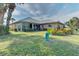 House exterior showcasing a large backyard and golf course view at 1558 Belfry Dr, Venice, FL 34292