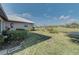 Landscaped backyard with golf course and pond views at 1558 Belfry Dr, Venice, FL 34292