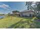 Backyard view, showcasing a tranquil water view and green space at 1558 Belfry Dr, Venice, FL 34292