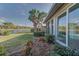View of the backyard with a pond and lush landscaping at 1558 Belfry Dr, Venice, FL 34292