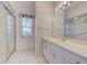 Bathroom with a vanity, shower, and striped wallpaper at 1558 Belfry Dr, Venice, FL 34292