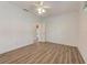 Simple bedroom with wood-look floors and ceiling fan at 1558 Belfry Dr, Venice, FL 34292
