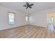 Large bedroom with neutral walls and laminate wood floors at 1558 Belfry Dr, Venice, FL 34292