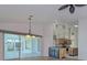 Dining room with view to backyard and kitchen at 1558 Belfry Dr, Venice, FL 34292