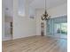 Dining room with chandelier, high ceilings, and hardwood floors at 1558 Belfry Dr, Venice, FL 34292