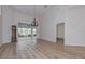 Bright dining room with hardwood floors and view to the backyard at 1558 Belfry Dr, Venice, FL 34292