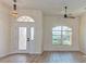 Entryway with light walls, laminate floor, and arched window at 1558 Belfry Dr, Venice, FL 34292