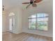 Entryway with an arched window, white door and laminate floors at 1558 Belfry Dr, Venice, FL 34292
