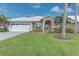 Single-story home with a two-car garage and landscaped lawn at 1558 Belfry Dr, Venice, FL 34292