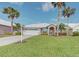 Single-story home with a two-car garage and a well-maintained lawn at 1558 Belfry Dr, Venice, FL 34292