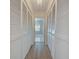 Long hallway with built-in storage and light flooring at 1558 Belfry Dr, Venice, FL 34292