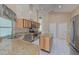Kitchen boasts granite counters, wood cabinets, and stainless steel appliances at 1558 Belfry Dr, Venice, FL 34292
