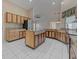 Bright kitchen with granite island and wood cabinets at 1558 Belfry Dr, Venice, FL 34292
