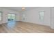 Bright living room with sliding glass doors and laminate flooring at 1558 Belfry Dr, Venice, FL 34292