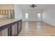 Open living area with light wood flooring and ceiling fan at 1558 Belfry Dr, Venice, FL 34292