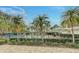 Community pool area with lush landscaping and lounge chairs at 1558 Belfry Dr, Venice, FL 34292